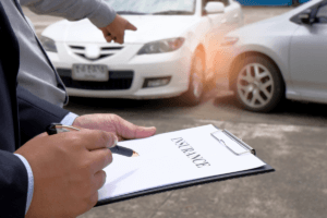 determining fault in a car accident- insurance adjuster inspecting damage